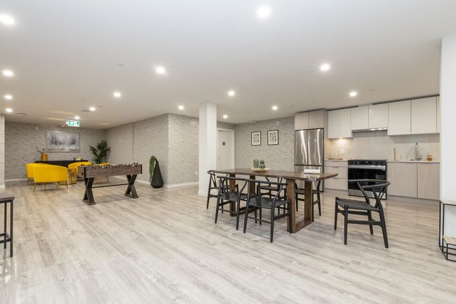 Dining area with light wood-style floors, recessed lighting, and wallpapered walls | Image 18