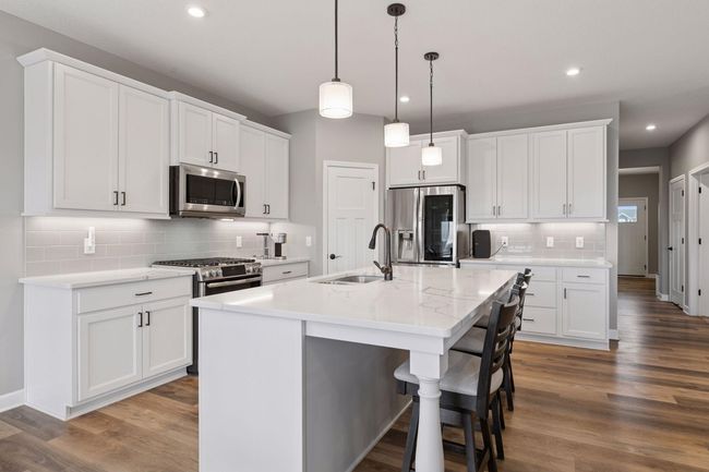 The kitchen with Quartz countertops, SS appliances, and white cabinets | Image 13