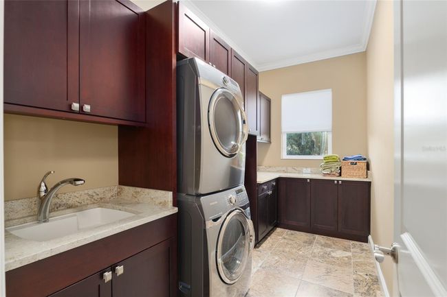 Large laundry room next to garage entrance | Image 54