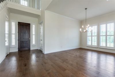 Stately entrance and foyer with study and dining room. Beautiful French Doors on the study and plantation shutters throughout the interior. (unstaged photo) | Image 3