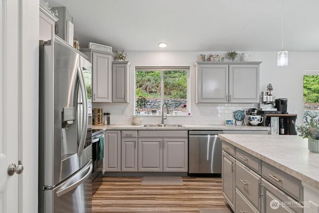 A kitchen where you can enjoy preparing meals. Soft pull cabinetry and take in the views. | Image 7