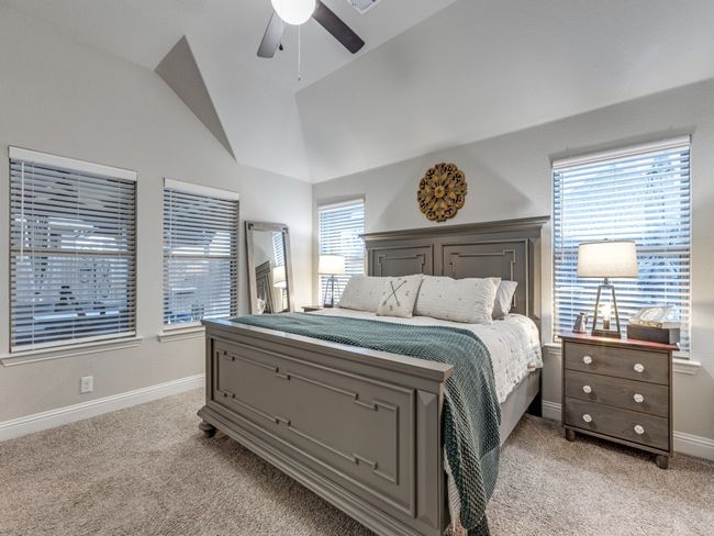 Bedroom with vaulted ceiling, light carpet, and ceiling fan | Image 21