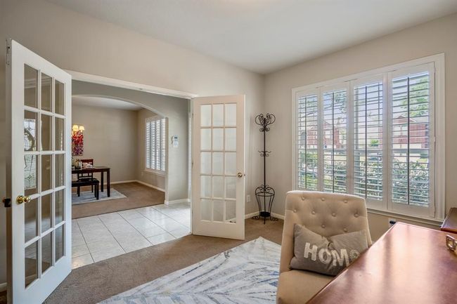 From the study, enjoy a view across the foyer into the formal dining room, showcasing the home's open and airy layout. | Image 8