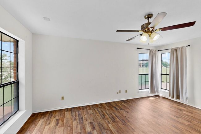 Empty room featuring wood finished floors, a ceiling fan, and baseboards | Image 21