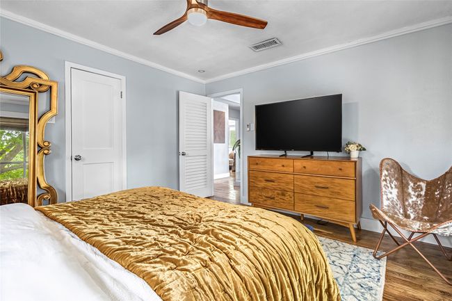 Bedroom featuring ornamental molding, wood finished floors, ceiling fan, and baseboards | Image 23
