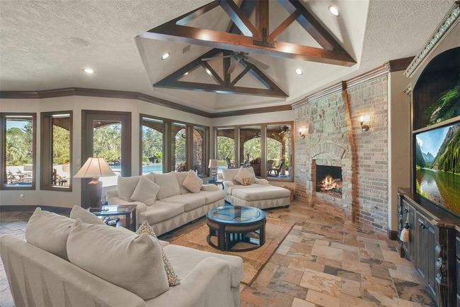 Guests can gather in the living room and warm up by the fireplace | Image 19