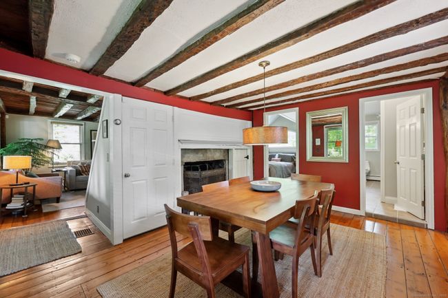 Yesteryear charm with its exposed beams, fireplace and wide board flooring. | Image 6