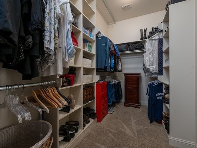 Walk in closet with visible vents and carpet floors | Image 23