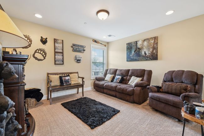 The upstairs loft area features cozy carpeted flooring and a single window that brings in natural light. 1107 Sycamore Leaf Way Murfreesboro, TN 37129 | Image 22