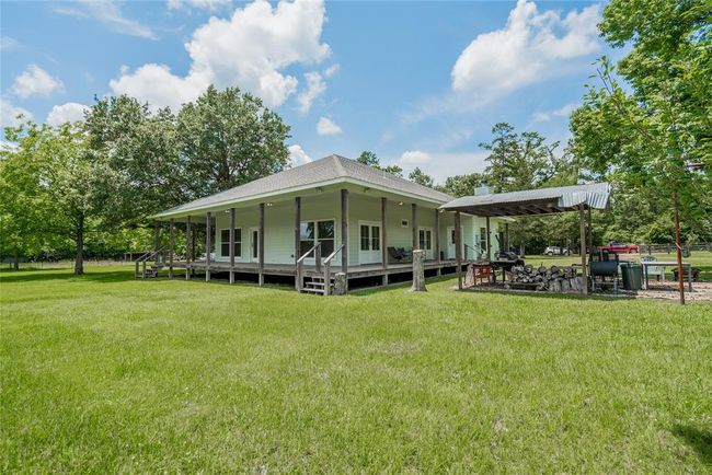 Each porch has a set of stairs and all the porches are fully lighted. Beautiful trees surround the house. | Image 7