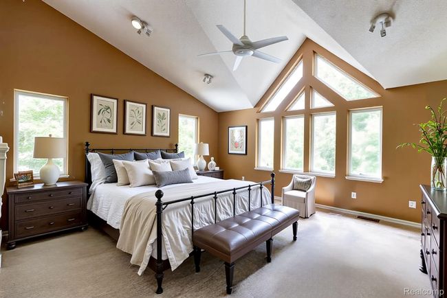 Bedroom featuring high vaulted ceiling, a ceiling fan, and carpet | Image 16