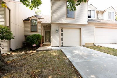 Townhome / multi-family property featuring a garage | Image 2