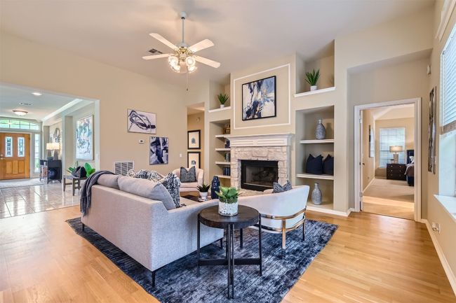 Lovely refinished engineered hardwood floors, built-ins on either side of fireplace | Image 15