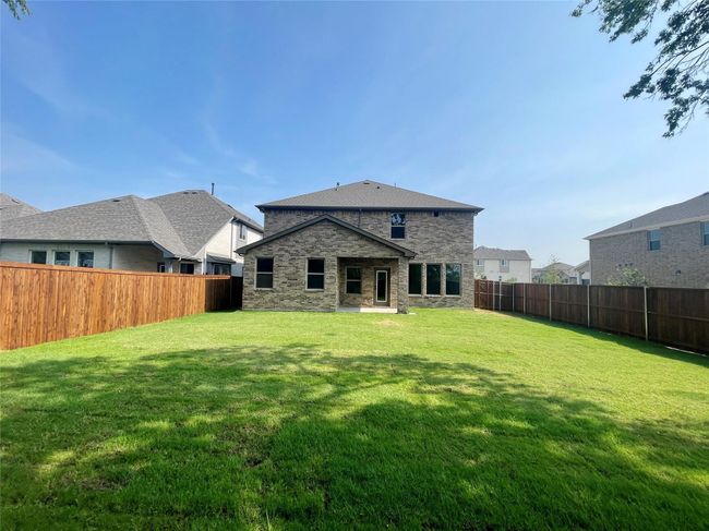 Back of property featuring stone siding and a fenced backyard | Image 38