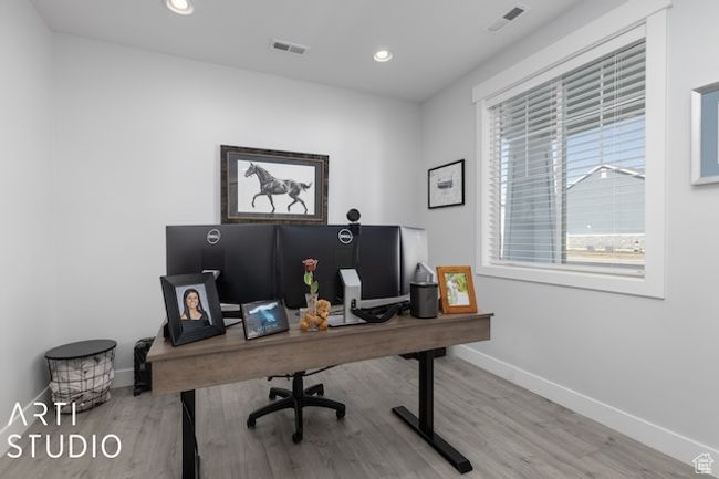 Home office featuring wood finished floors, recessed lighting, baseboards, and visible vents | Image 6