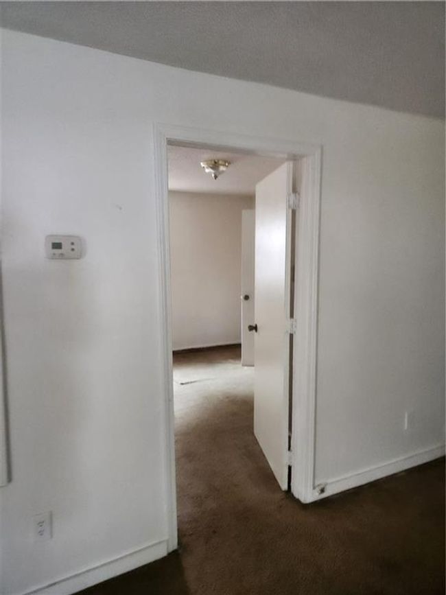 Hall featuring dark carpet | Image 9
