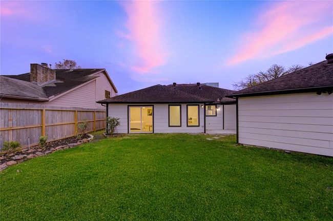 The backyard offers an expansive green space, providing endless possibilities for outdoor living. Whether you envision a play area, garden, or outdoor entertaining space, this yard has the size and flexibility to bring your ideas to life. | Image 29