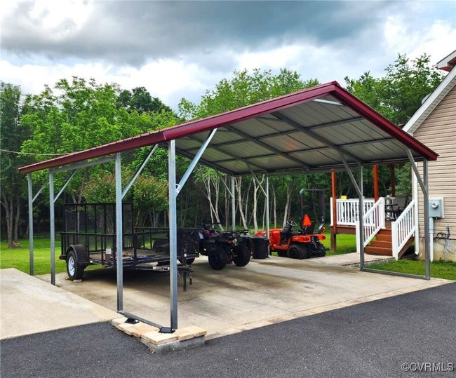 View of parking / parking lot featuring a carport | Image 39