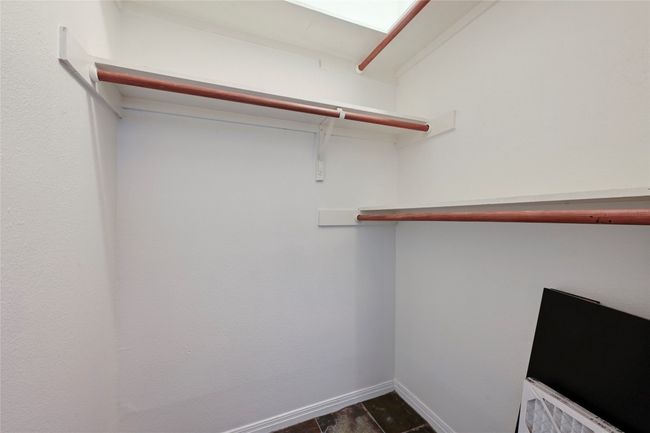 A large walk in closet with attic access. | Image 17