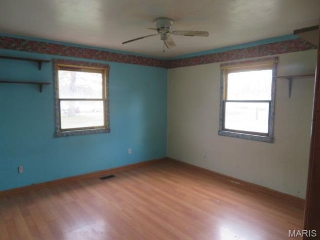 Spare room featuring plenty of natural light, ceiling fan, and wood-type flooring | Image 5