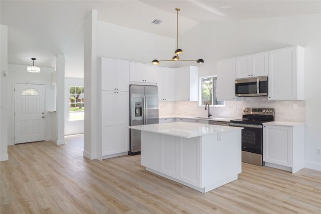 Updated kitchen with an island to gather around. | Image 10