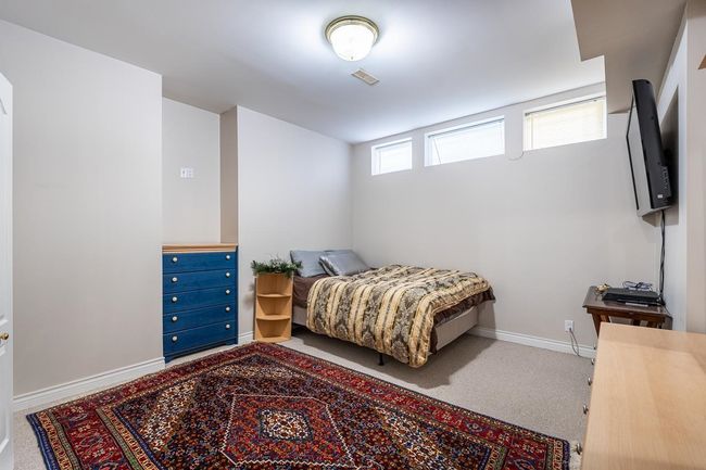 Bedroom featuring baseboards, visible vents, and carpet | Image 34
