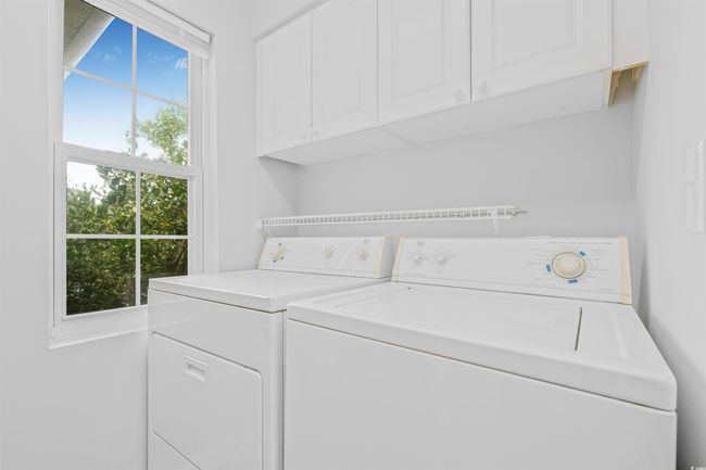 Washroom with cabinet space and washing machine and dryer | Image 29