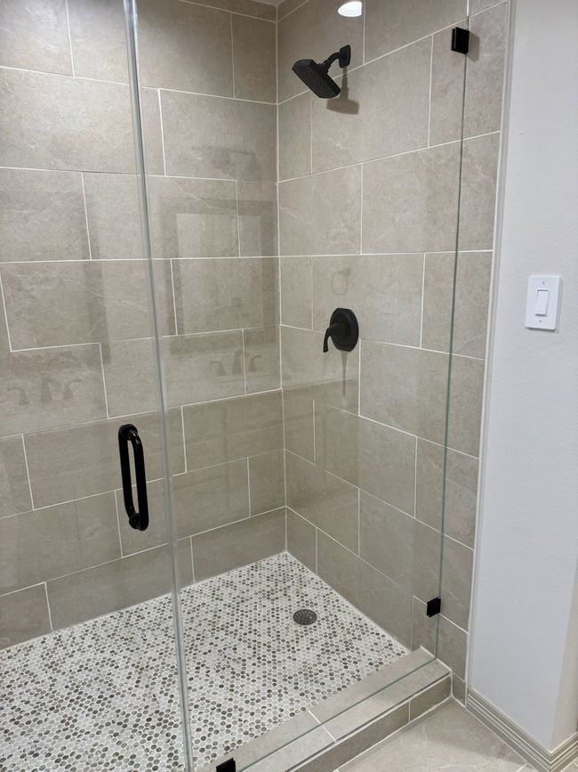 Bathroom featuring a walk-in shower stall | Image 12