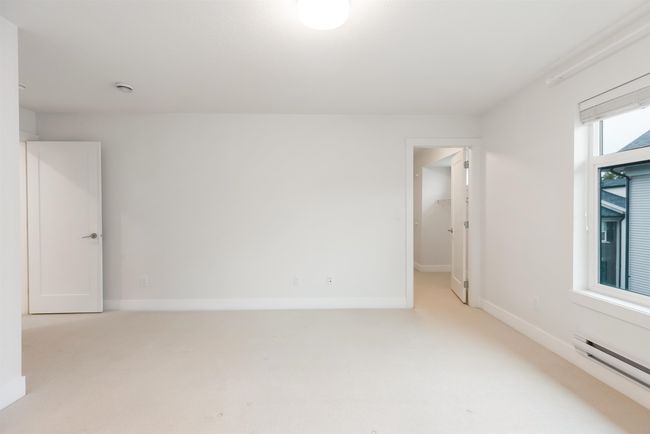 Empty room featuring a baseboard radiator, light carpet, and baseboards | Image 16