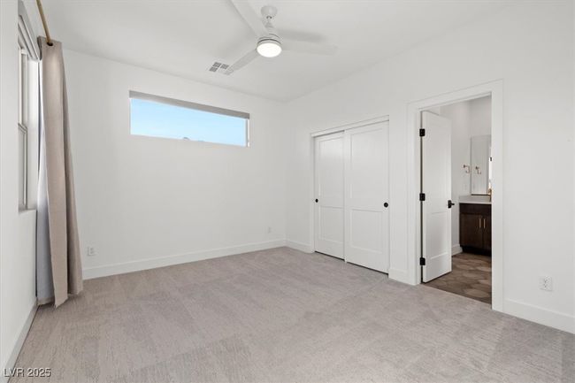 Unfurnished bedroom with carpet floors, a closet, ensuite bathroom, baseboards, and visible vents | Image 42