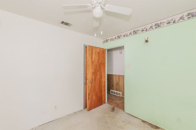 Empty room featuring ceiling fan and concrete floors | Image 27