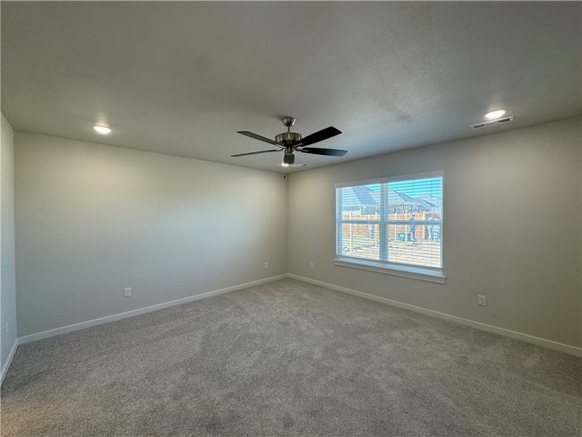 Indulge in the serene luxury of the expansive master bedroom, offering a spacious retreat where comfort and tranquility harmonize, inviting you to unwind and rejuvenate in style. | Image 10