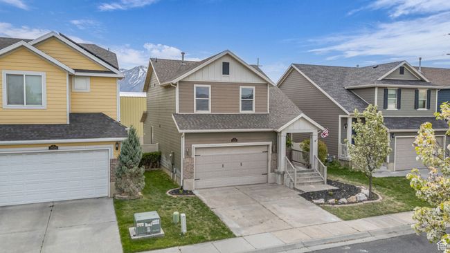 View of front facade featuring an attached garage, driveway, and roof with shingles | Image 26