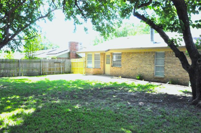 Rear view of property with brick siding, a yard, and fence | Image 30