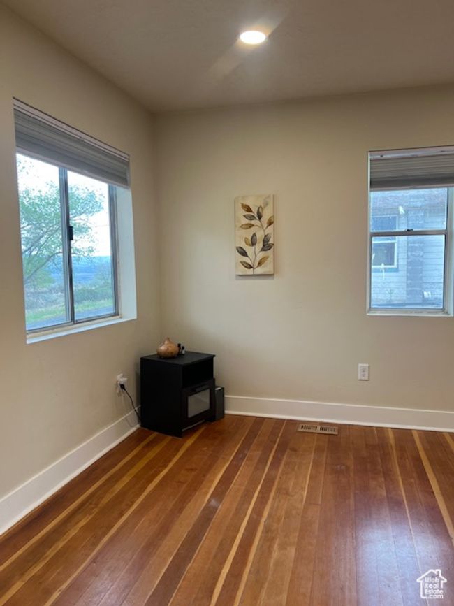 Entry to main living room with restored original hardwood flooring. | Image 11