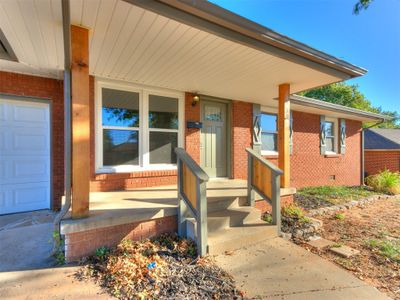 Entrance to property featuring a porch and a garage | Image 3