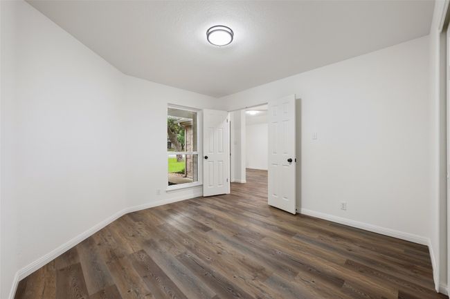 Empty room featuring baseboards and dark wood finished floors | Image 13