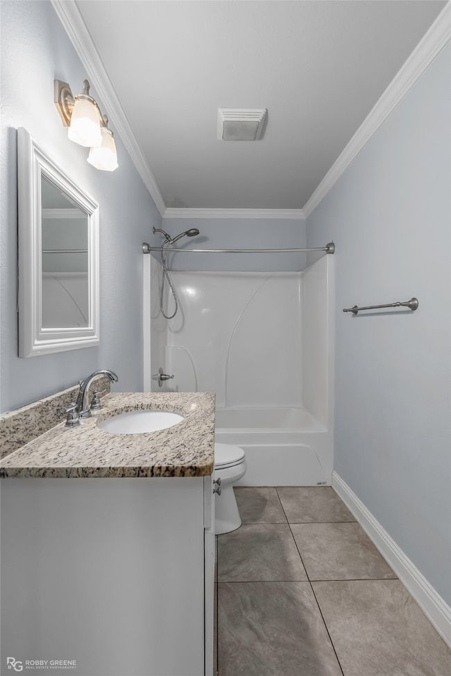 Bathroom with ornamental molding, toilet, washtub / shower combination, and vanity | Image 12