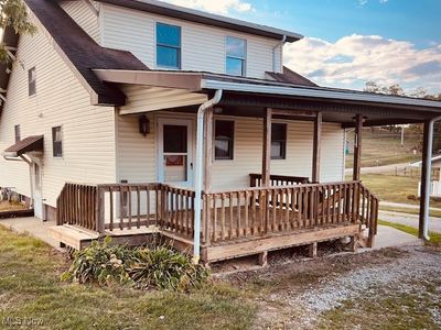 View of front of house with a front lawn and a porch | Image 1