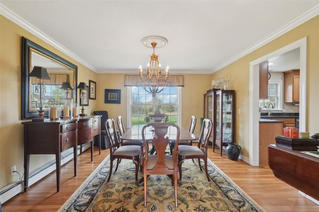 Dining room with baseboards, a chandelier, light wood-style floors, and recessed lighting | Image 18