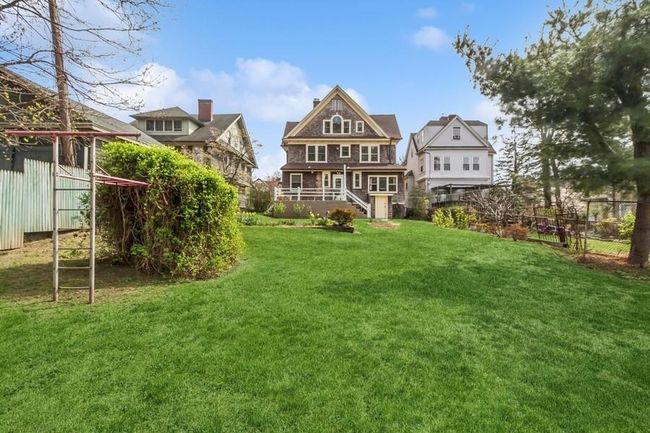 rear of house featuring a yard and fence | Image 38