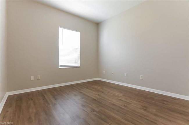Spare room featuring dark wood finished floors and baseboards | Image 13