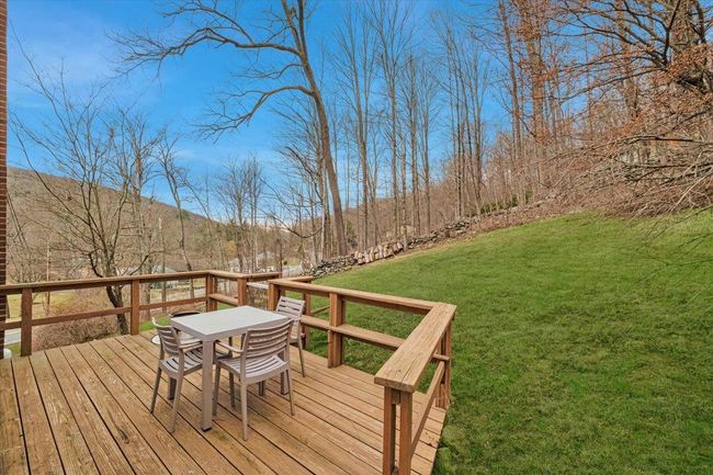 Wooden deck featuring a lawn and a mountain view | Image 17