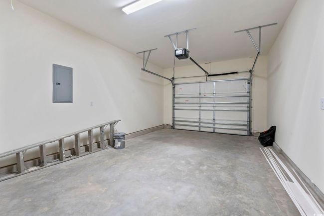 Garage with electric panel and a garage door opener | Image 21