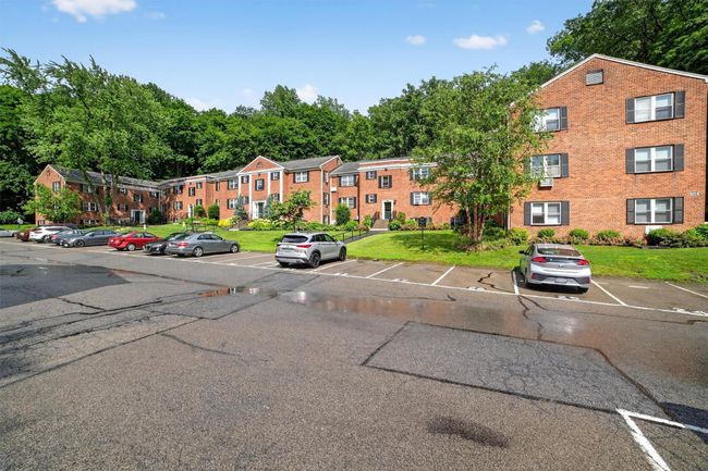 View of building exterior featuring uncovered parking | Image 26