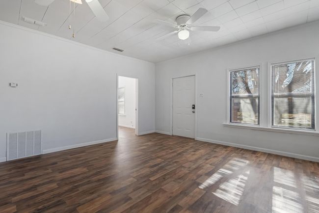 Spare room featuring dark hardwood / wood-style flooring, crown molding, and ceiling fan | Image 6