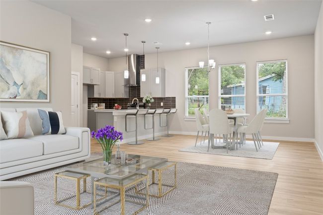 A stunning living room with an open floor plan, seamlessly flowing into the dining area and cozy kitchen (virtually staged). | Image 4