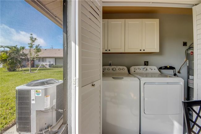 Laundry area with cabinets and washing machine and clothes dryer | Image 11