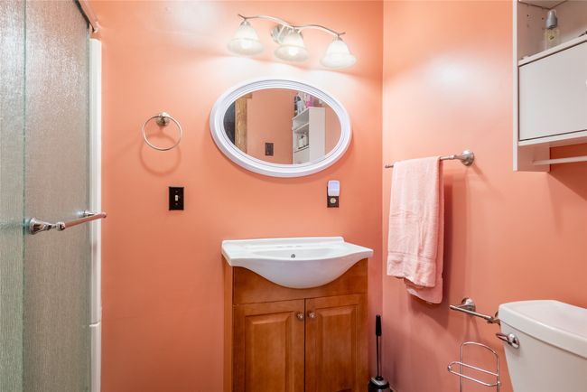 Bathroom with vanity and a shower with shower door | Image 44