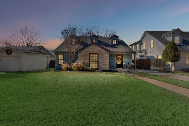 View of front of house with a yard, covered porch, a garage, and an outdoor structure | Image 40